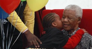 A child kisses Nelson Mandela, Friday, July 31, 2009 during the launch of a children's hospital in Johannesburg, South Africa.	 (AP/Karel Prinsloo)