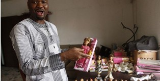 Entrepreneur Taofick Okoya in his Lagos workshop, where he makes dolls dressed in local attire. Photographs: Akintunde Akinleye/Reuters