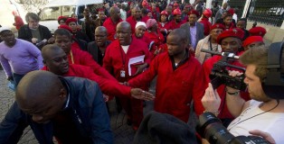 South Africa's Economic Freedom Fighters parliament members and their leader Julius Malema (C) march outside the parliament after being ordered to leave the general assembly in Cape Town on August 21, 2014 (AFP Photo/Rodger Bosch)