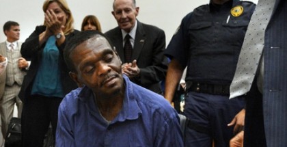 Henry McCollum sits quietly as thunderous applause rings out around him in a Robeson County courtroom on Tuesday. Photograph: Chuck Liddy/AP