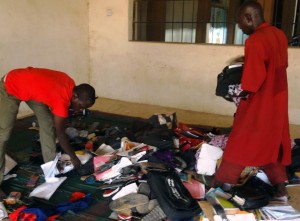 A student rummages through personal effects abandoned at the Federal College of Education in the northern Nigerian city of Kano, on September 17, 2014 (AFP Photo/) 