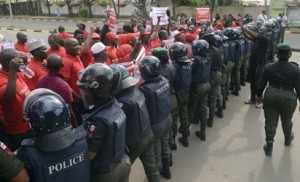 Policewomen block supporters of the #BringBackOurGirls campaign, who ask for the release of the 219 Chibok schoolgirls kidnapped by Boko Haram militants, from marching to the president’s official residence in the Nigerian capital Abuja on October 14, 2014. Nigerian police on Tuesday blocked supporters of 219 schoolgirls kidnapped by Boko Haram militants from marching on the president’s official residence on the six-month anniversary of the abduction. A wall of female officers in full riot gear formed the first line of a barricade in front of less than 100 members of the Bring Back Our Girls campaign, preventing them from setting out. AFP PHOTO