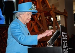 Britain's Queen Elizabeth presses a button to send her first Tweet during a visit to the 'Information Age' Exhibition at the Science Museum, in London October 24, 2014. Credit: REUTERS/Chris Jackson/Pool