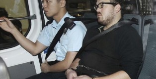 Rurik George Caton Jutting is escorted by a police officer in an police van before appearing in a court in Hong Kong.(Photo: AP)
