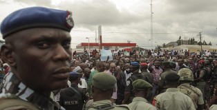 Police in Port Harcourt, Nigeria, monitor members of the opposition party All Progressives Congress (APC) as they protest against elections on March 29. (Tife Owolabi / European Pressphoto Agency)