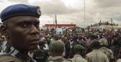 Police in Port Harcourt, Nigeria, monitor members of the opposition party All Progressives Congress (APC) as they protest against elections on March 29. (Tife Owolabi / European Pressphoto Agency)